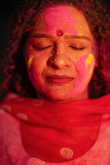 Close view of Indian woman face covered with powder paint during Holi festival