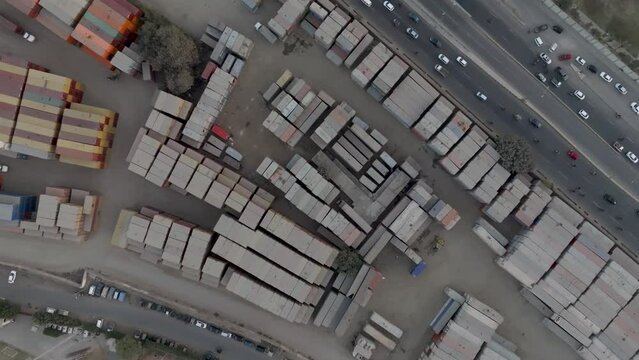 Aerial Birds Eye View Of Dusty Stacked Cargo Containers At Storage Site In Karachi. Pedestal Up