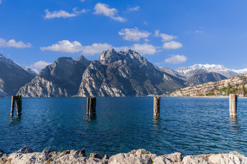 Beautiful view of Lake Garda with clear blue waters and the peaks of the Alpine mountains