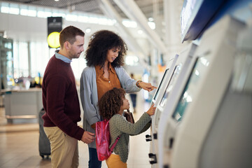 Family, self service and travel at airport for check in, registration or booking flight online...