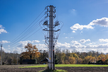 Energy infrastructure against the background of buildings, forest and sky