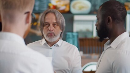 Restaurant manager instruct waiters before opening. Realtime