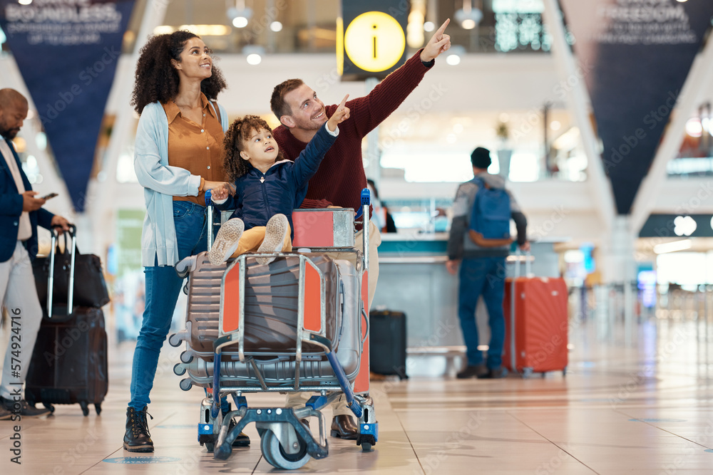 Canvas Prints Pointing, travel and interracial family at the airport looking at a departure time for a flight. Happy, trip and parents with a child to look at information for arrival or leaving of an airplane