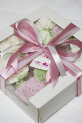 Homemade marshmallows in a cardboard box. Zephyr flowers. Gift wrap. Tied with ribbon.