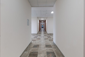 white empty long corridor with red brick walls for room office in interior of modern apartments, office or clinic