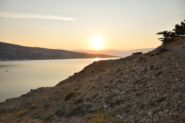 Plakat stone slope above the sea in croatia. landscape at sunset.
