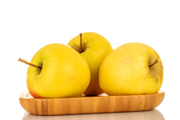 Several ripe juicy apples on a bamboo plate, macro, isolated on white background.
