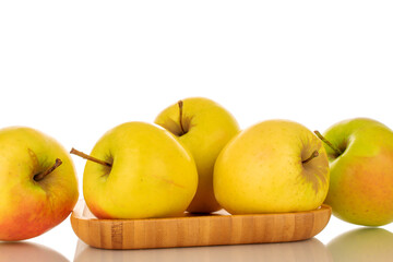Several ripe juicy apples on a bamboo plate, macro, isolated on white background.