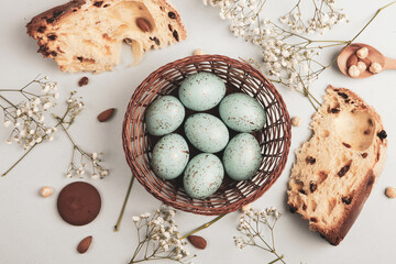 banner. Easter frame with eggs and feathers on a blue wooden background. Minimal concept. View from above. Card with copy space for text.