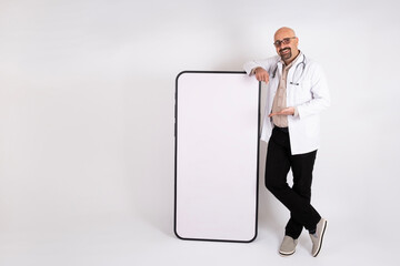 Medical app concept idea, caucasian male doctor leaning at big smartphone with blank screen for...