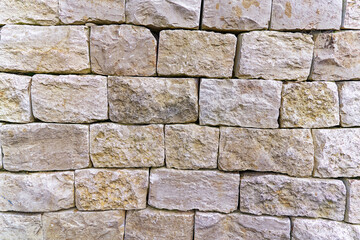 Close-up of ocher natural stone wall at river bank of Rhine River on a foggy winter day. Photo...