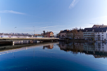 Scenic view of Rhine River at Swiss City of Schaffhausen with car bridge on a sunny winter day. Photo taken February 16th, 2023, Schaffhausen, Switzerland.