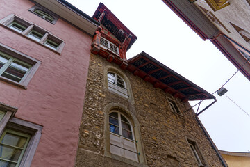 Stone facade of historic house at alley of the old town of Swiss City of Schaffhausen on a foggy winter day. Photo taken February 16th, 2023, Schaffhausen, Switzerland.