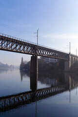 Scenic view of Rhine River at City of Schaffhausen with railway bridge and village of Feuerthalen in the background on a sunny winter day. Photo taken February 16th, 2023, Schaffhausen, Switzerland.