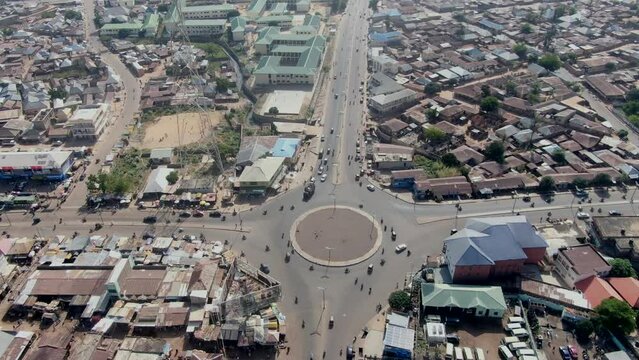 Roundabout intersection with car and motorcycle traffic in Gombe, Nigeria - aerial orbit
