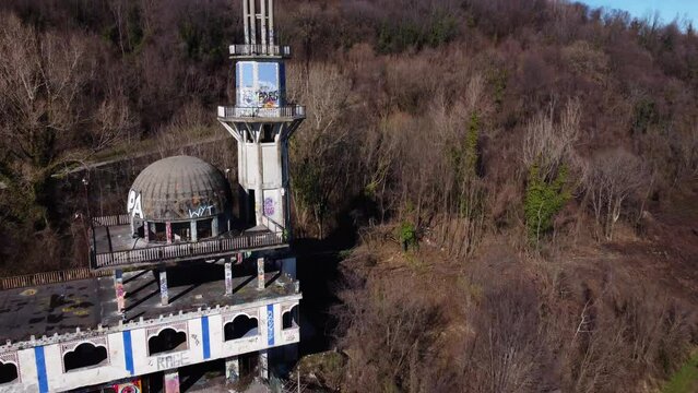 Aerial Flying Over The Minaret At Abandoned Ghost Town Consonno. Dolly With Tilt Up Shot
