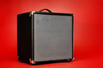 classic guitar amplifier isolated on red background