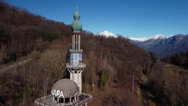 Aerial View Of The Minaret Tower At Abandoned Ghost Town Consonno. Dolly Back Shot