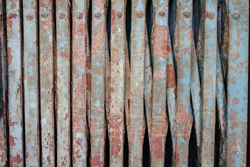 Background of a contracted rusty red blue metal grille.