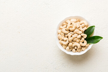 cashew nuts in wooden bowl on table background. top view. Space for text Healthy food
