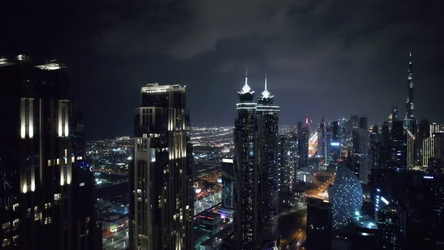 Flying a drone over a night Dubai. Aerial view