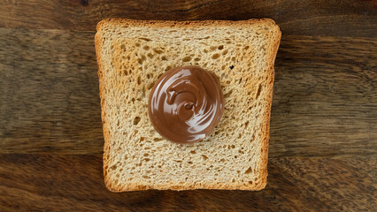 Сhocolate paste on roasted toast bread. Perfect traditional breakfast