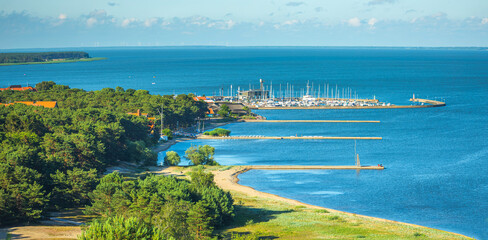 Bay of the Nida resort. Lithuania. Blooming flowers and a sculpture in city center