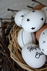 White marker decorated Easter eggs in the nest