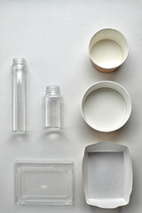 Various disposable tableware bottles and containers on a white background