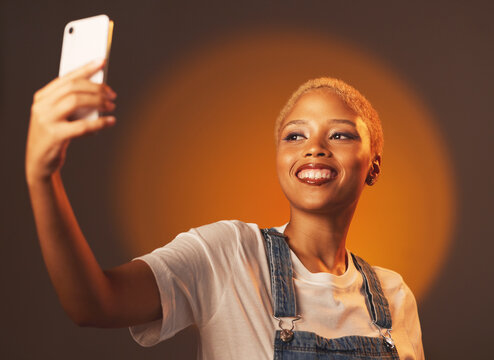 Beauty, selfie and black woman in studio for makeup, fun and spotlight aesthetic on gradient background. Social media, girl and fashion influencer smile for blog, profile picture or homepage update