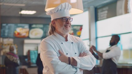 Portrait of mature male chef and restaurant owner . Realtime