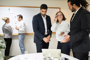 Business people in the international start-up team at the computer
