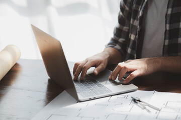 Architects and engineers are working together to edit the draft house plan that was designed after...