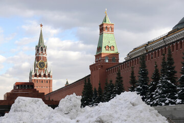 Fototapeta premium Red Square in Moscow covered with large high snow drifts snow and gloomy clouds above on overcast day