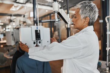 Eye exam, optometry and optometrist woman for vision consultation, medical or healthcare lens expert. Eyes check or consulting client, person or patient with professional doctor and phoropter machine