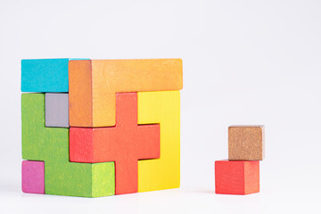 Colorful wooden cube puzzle. Geometric shapes on a white background.