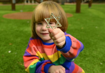 The little boy holds the star of David. Concept: children in Israel, repatriation with children,...
