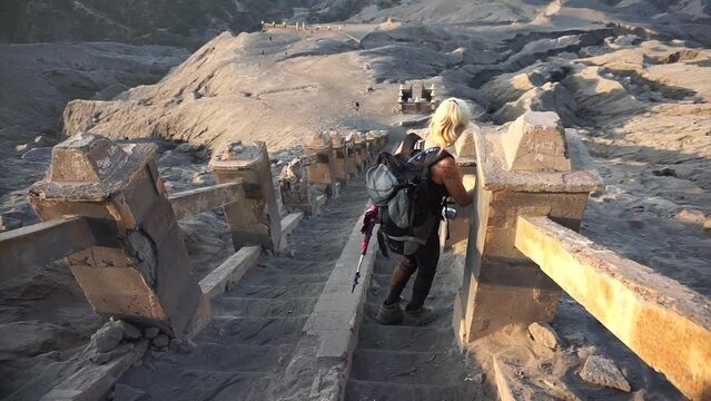 A woman standing and taking picture around Bromo National park.