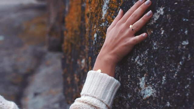 Nature, touch and rock with woman hands feeling texture, surface or terrain of mountain. Travel, trekking and ecology with female palm on stone, boulder or canyon wall formation in outdoors