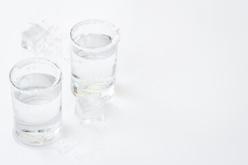 Glasses of tequila with lime and salt. Strong alcohol background