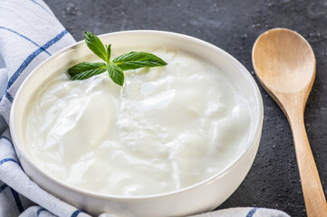 Homemade Yogurt with cream in bowl on rustic table, healthy food