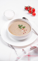 Cream soup with vegetables on cream on a white table. Soup for lunch.
