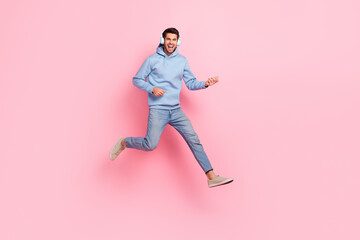 Fototapeta na wymiar Photo of carefree crazy man performer wear blue stylish clothes plating guitar festive performance isolated on pink color background