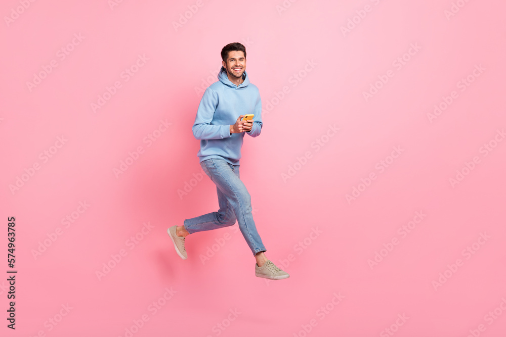 Poster full length photo of positive stylish man user moving empty space sale modern devices gadgets isolat