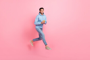 Fototapeta na wymiar Full length photo of positive stylish man user moving empty space sale modern devices gadgets isolated on pink color background