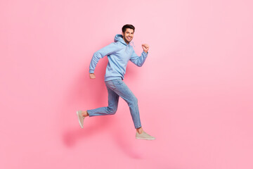 Fototapeta na wymiar Full length profile side photo of cheerful man wear blue clothes running empty space store mall center isolated on pink color background