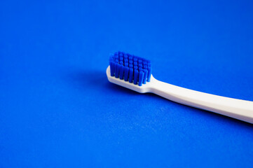 white toothbrush on blue background copy space. the concept of oral hygiene, dental care. Dental concept. health care. Oral hygiene.