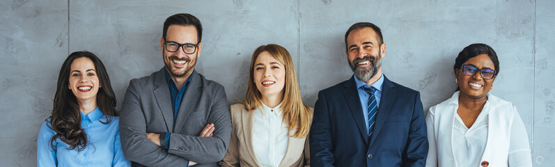 Multi-ethnic group of people in formal businesswear standing in a row. Group of business persons...