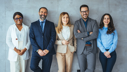 Portrait of multi-ethnic male and female professionals. Business colleagues are standing against wall. They are in formals at office. Confident individuals make a confident team. - obrazy, fototapety, plakaty