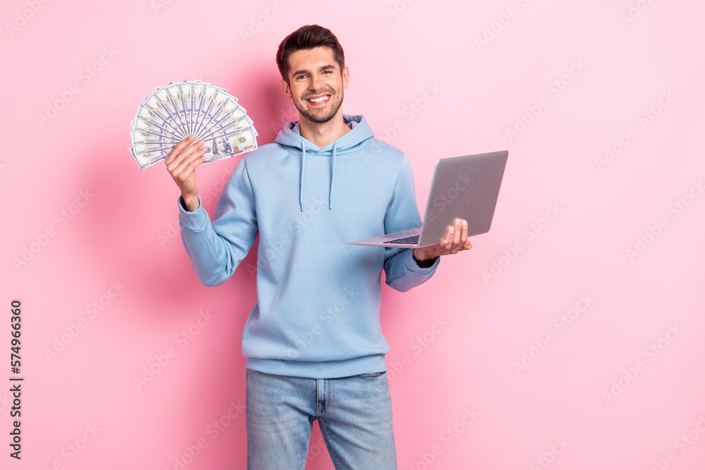 Poster Photo of charming cute guy dressed blue sweatshirt winning cash modern gadget isolated pink color background